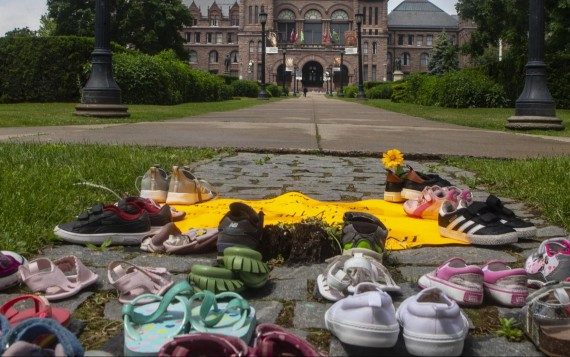 Kinderschuhe liegen auf dem Boden in Sichtweite des Regierungsgebäudes im kanadischen Bundesstaat Ontario. Sie sollen an die toten indigenen Kinder erinnern, deren Gräber auf dem Gelände einer ehemalgen